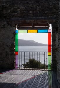 journeyintomindfulness.org.uk image: A balcony with stained glass looking onto a view of the sea and mountains in the distance